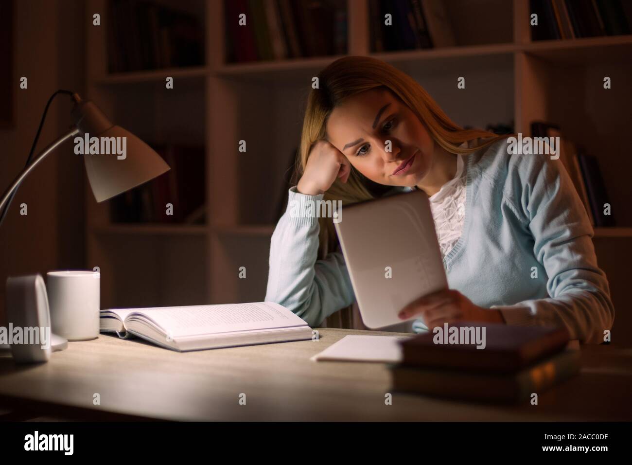 Student learning at home. Using digital tablet. Stock Photo