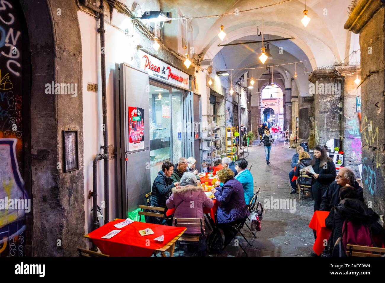 Restaurant under the portico, Via dei Tribunali, Naples, Italy Stock Photo