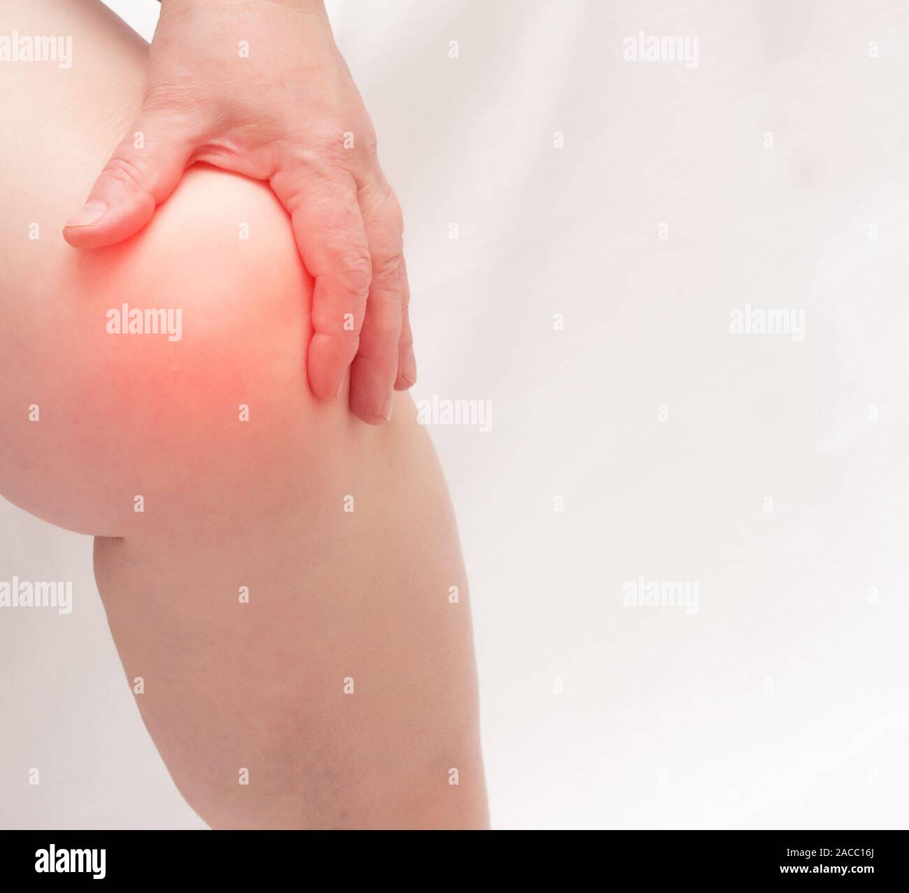 An elderly woman holds on to the knee joint on her leg. Pain and