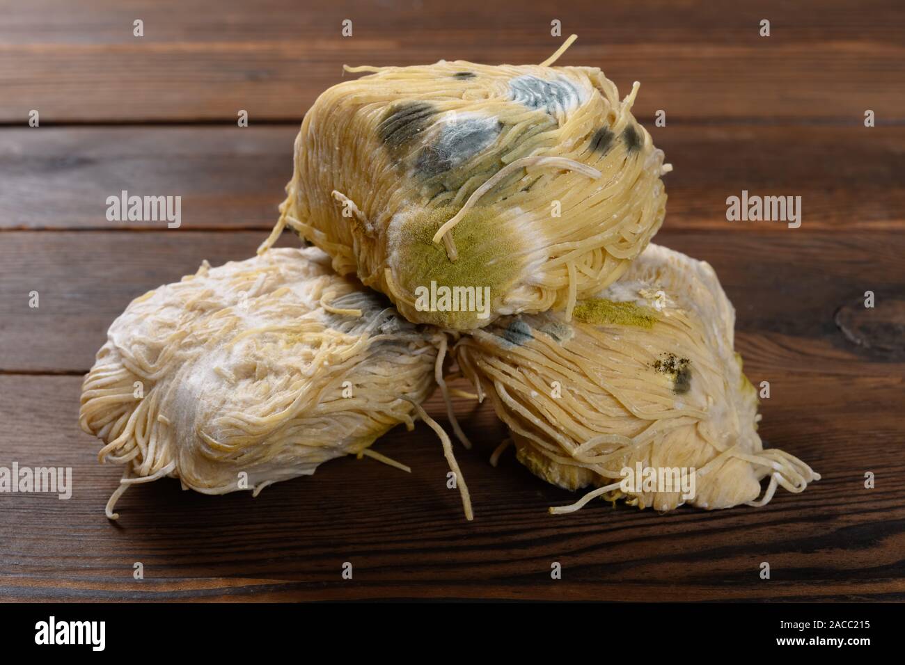 moldy noodles on a wood table Stock Photo Alamy