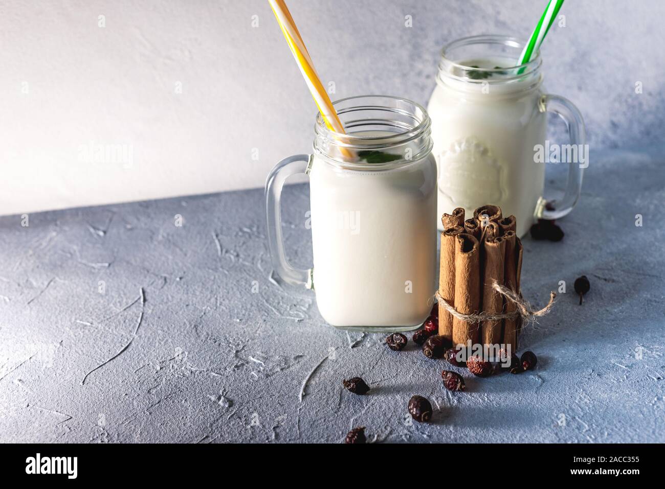 simple homemade kefir in a glass with spices and herbs on a gray ...