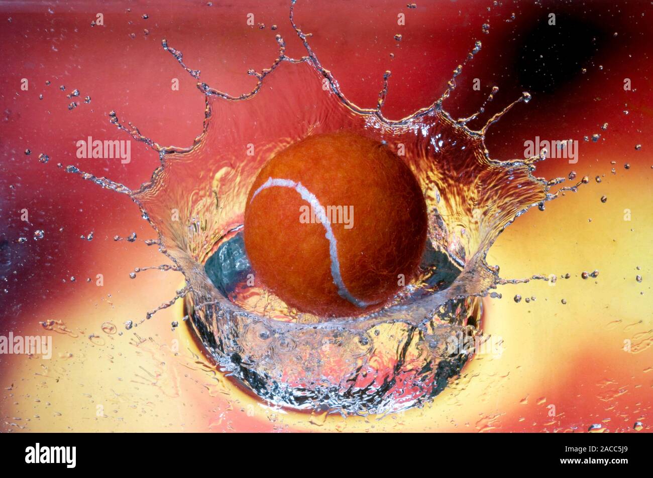 Tennis ball and splash. Highspeed photograph of the splash produced as a tennis ball bounces
