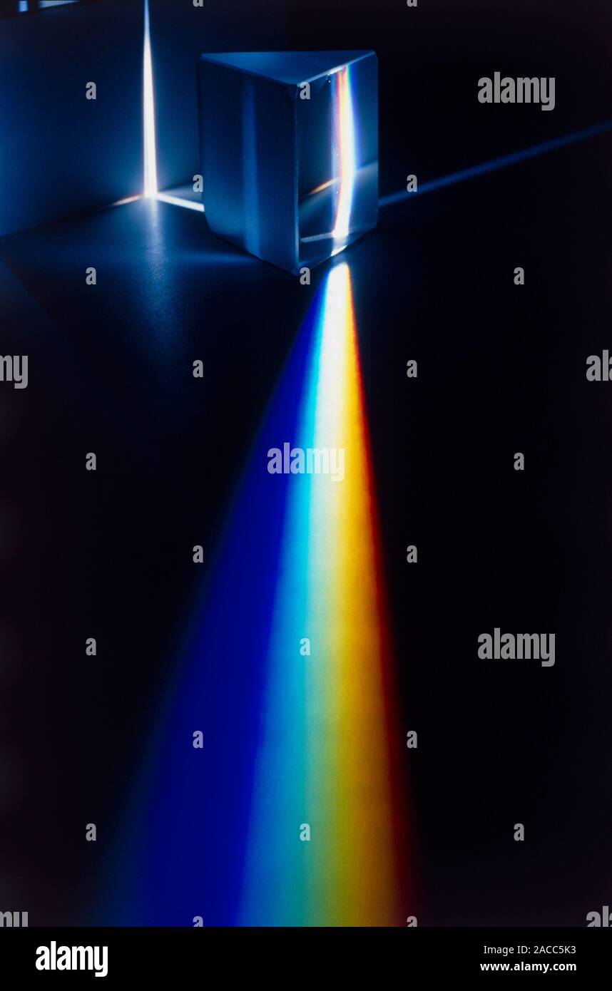 White light passing through triangular prism. Stock Photo