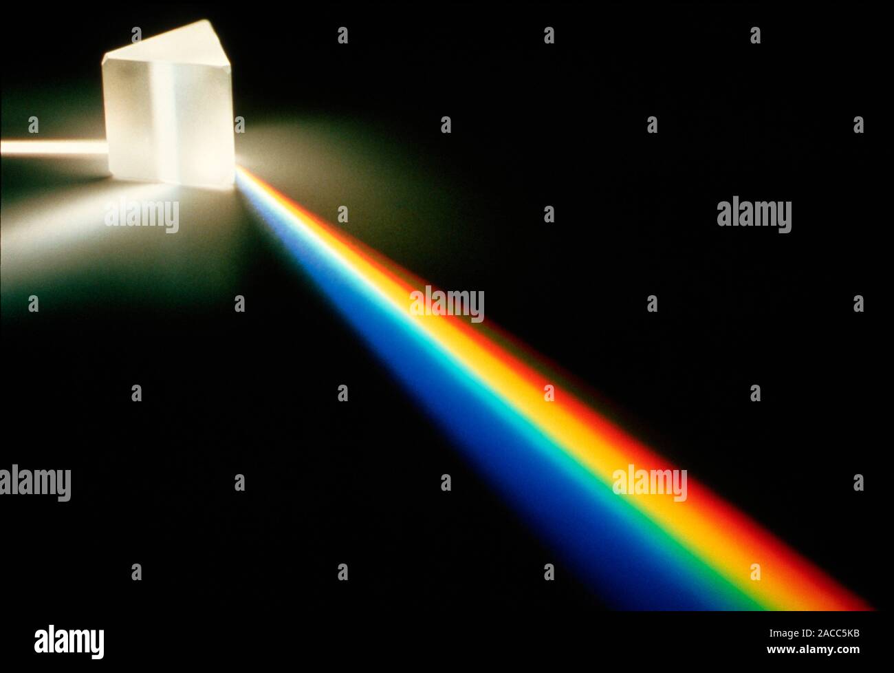 White light passing through triangular prism. Stock Photo