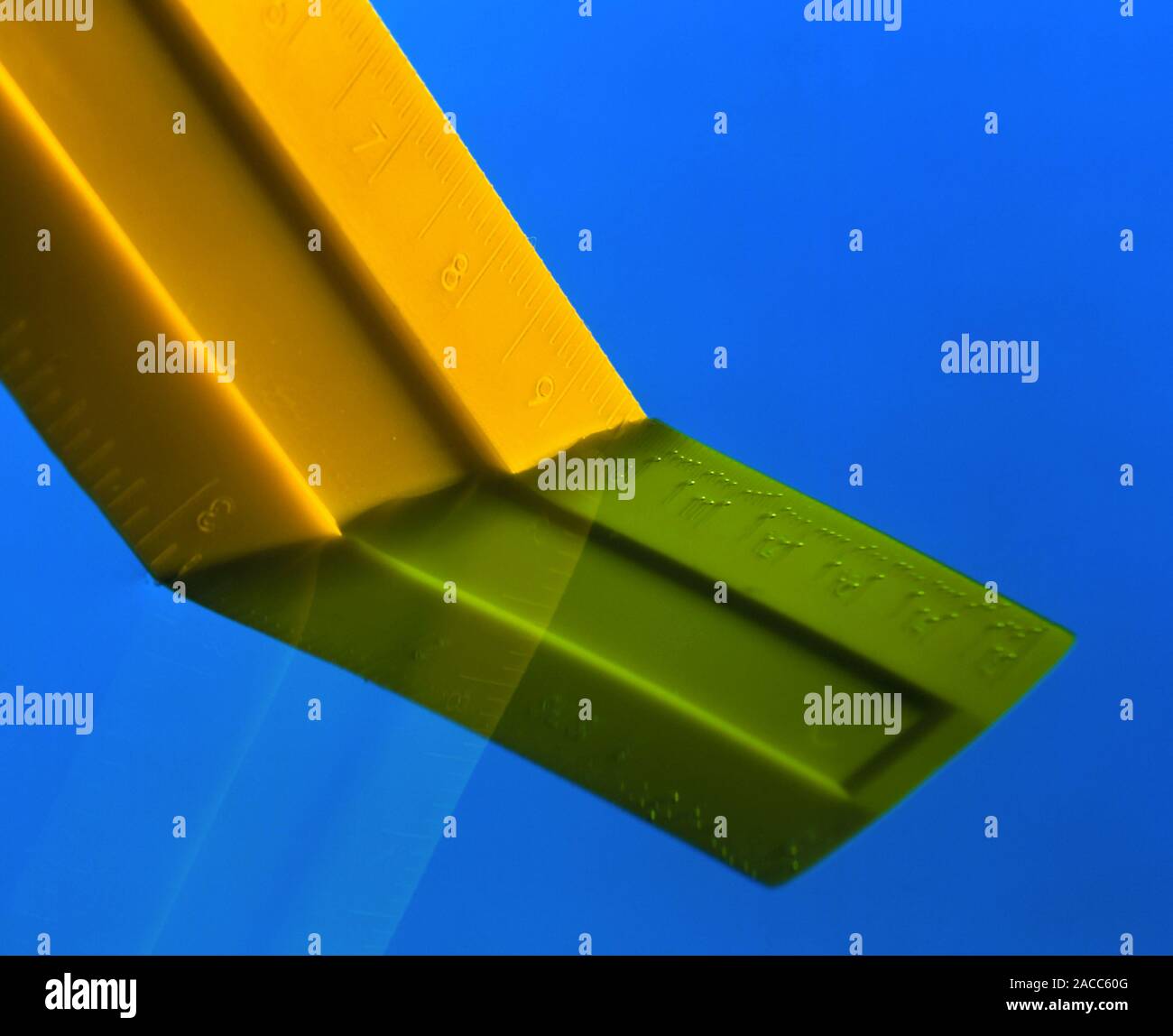 Optics Refraction Ruler Refraction. Refraction of an image of a ruler in transparent liquid ...