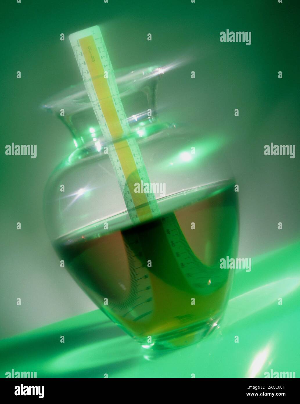 Refraction. Ruler in a jug of water showing the effects of refraction