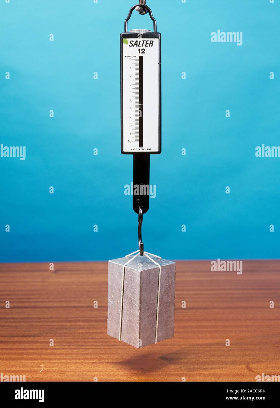 Weight in air and water, image 1 of 2. This mass is hanging from a