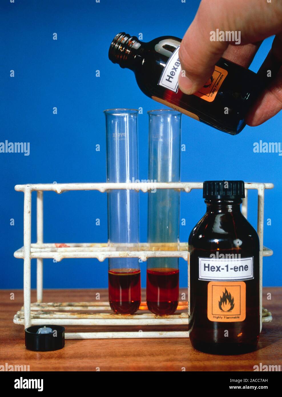 Alkene test. Image 1 of 2. Test tubes containing bromine water (brown