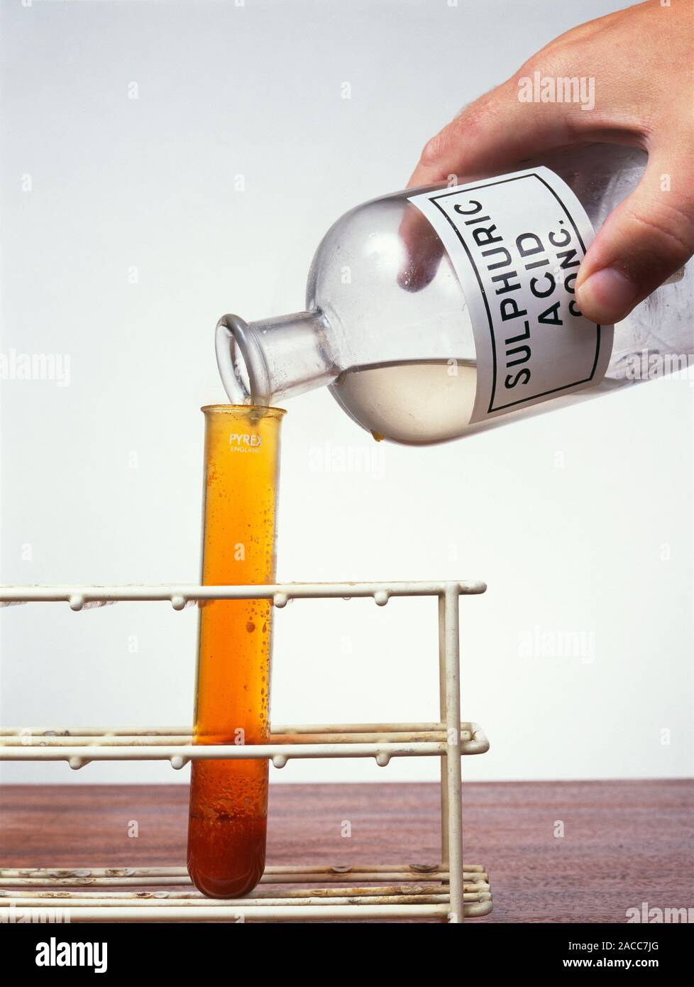 Bromine reaction. Bromine gas (orange) forming as the product of a