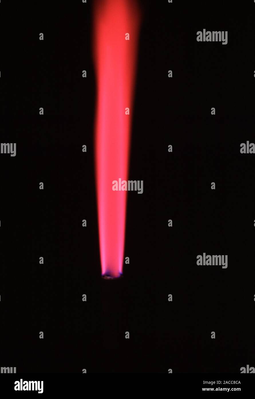 Flame test. Lithium burning in the flame of a bunsen burner producing a