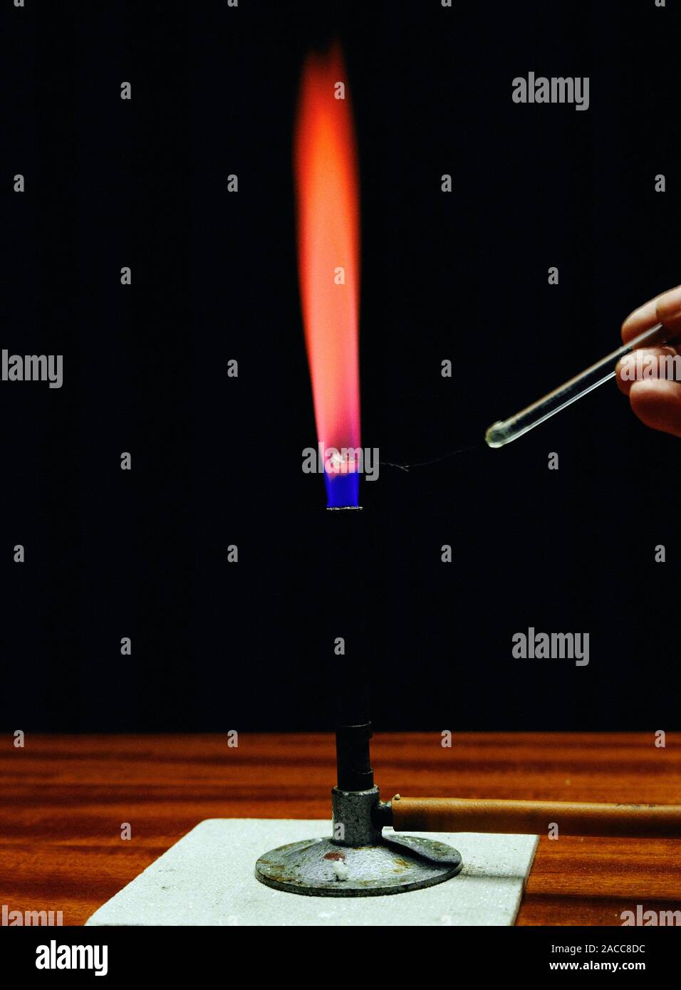 Flame test. Strontium burning in the flame of a bunsen burner producing