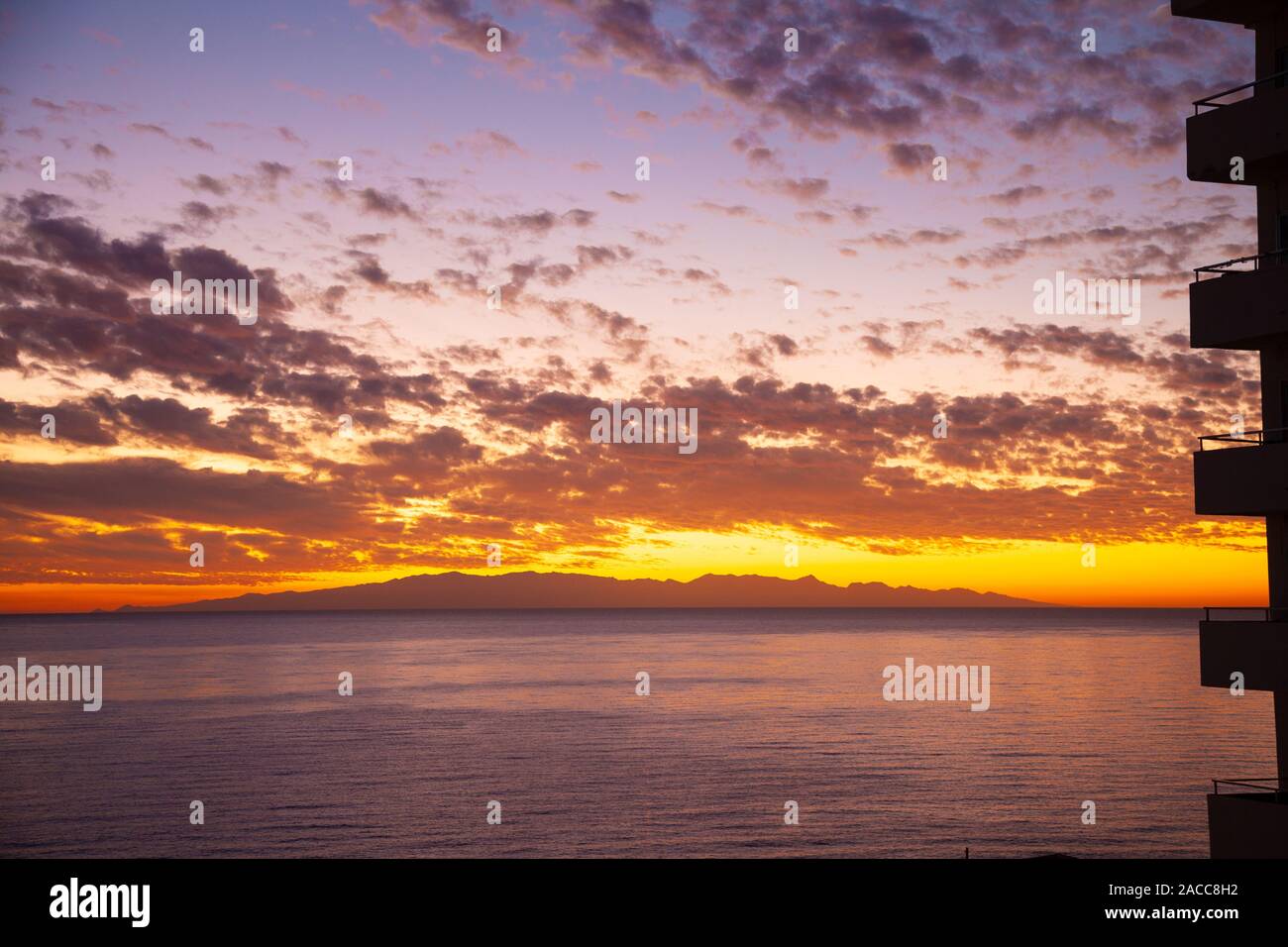 Sunrise over Gran Canaria Island from Las Caletillas near Santa Cruz,  Tenerife, Spain Stock Photo - Alamy
