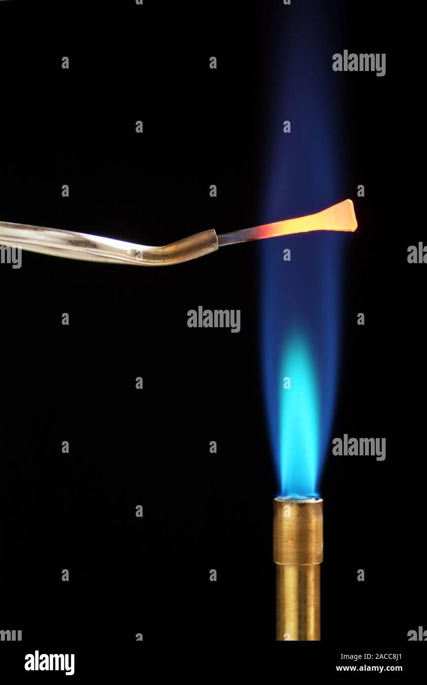 Heating an iron nail. Bunsen burner flame (blue) being used to heat an iron nail until it glows