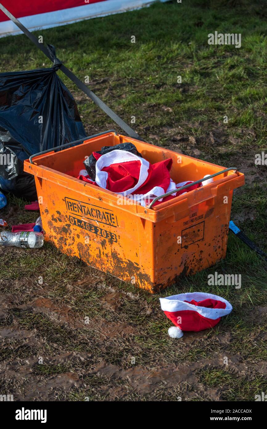 Orange plastic storage box filled with Santa's hats Stock Photo Alamy