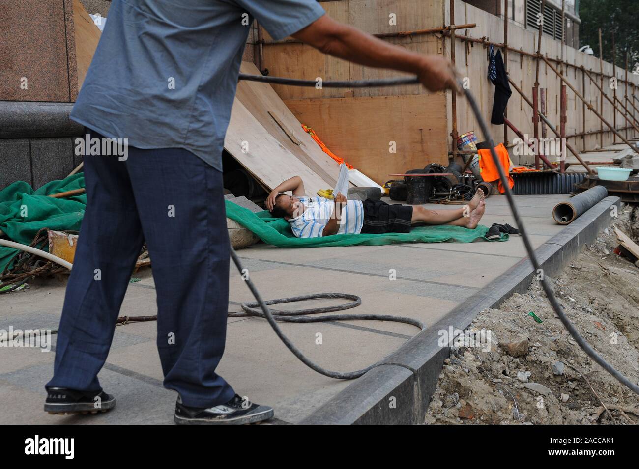 16.08.2012, Beijing, China, Asia - Two workers at a construction site in the central business district of the Chinese capital city. Stock Photo