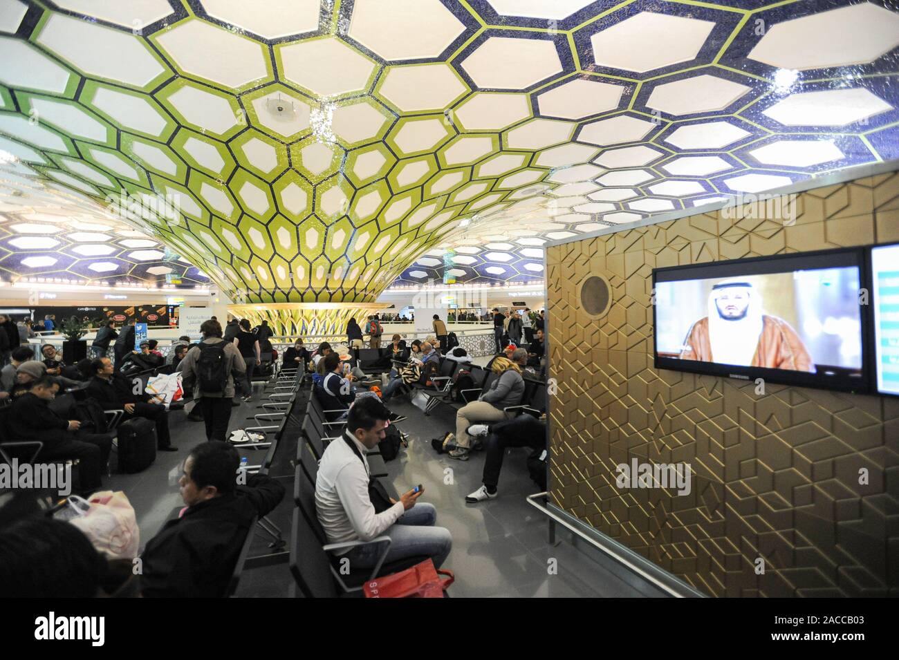 04.01.2014, Abu Dhabi, United Arab Emirates - Passengers wait for their connecting flights during a stopover in the transit hall inside the terminal. Stock Photo