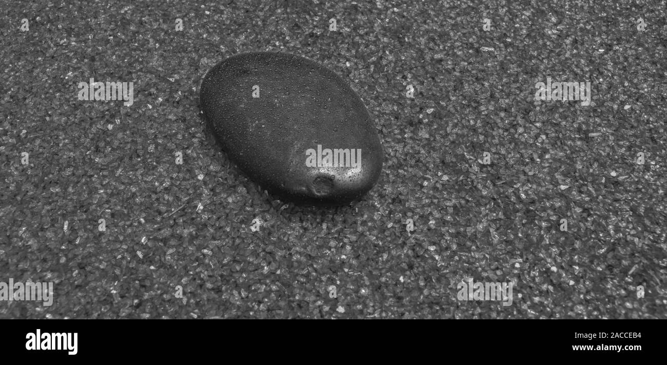 single river stone in fine ornamental sand with chromium shards Stock