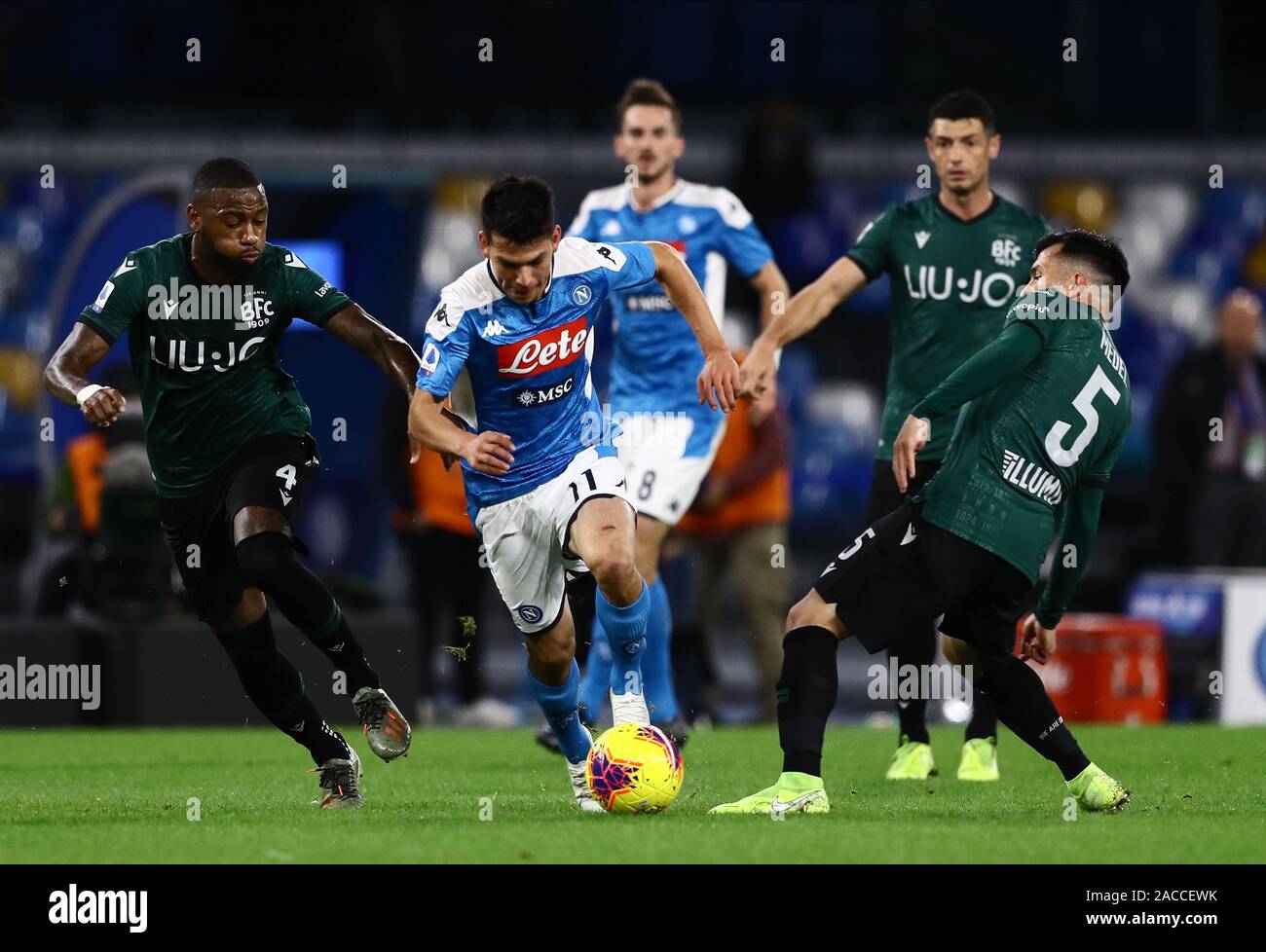 1st December 2019; Stadio San Paolo, Naples, Campania, Italy; Serie A Football, Napoli versus Bologna; Hirving Lozano of Napoli is challenged by Stefano Denswil of Bologna - Editorial Use Stock Photo