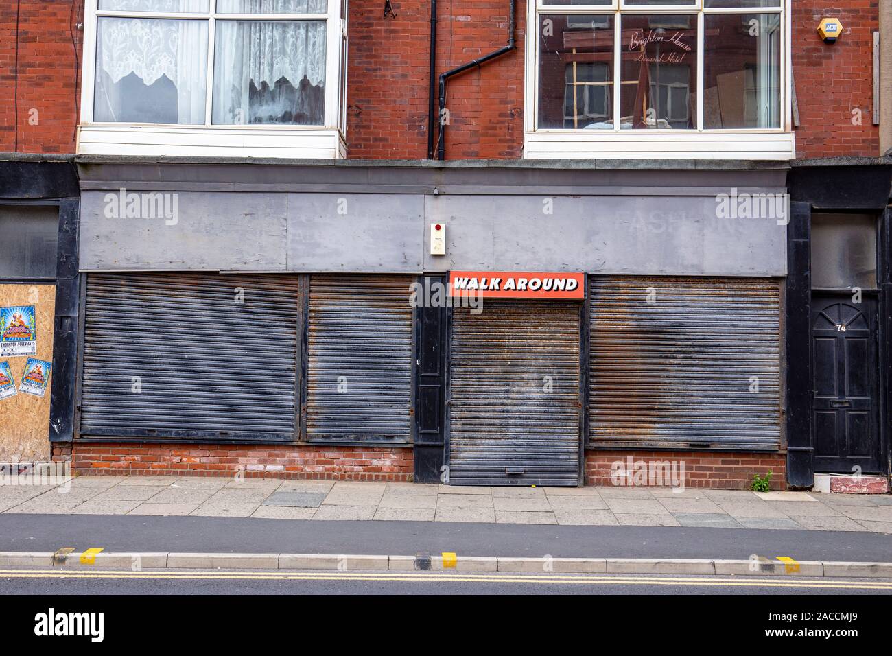 Walkaround sign on closed and shuttered shop in Blackpool Lancashire UK Stock Photo