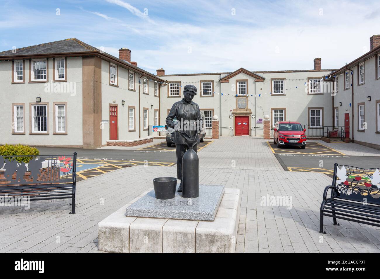 Munition Workers Statue and The Institute (Richard Greenhow Centre), Central Avenue, Gretna, Dumfries and Galloway, Scotland, United Kingdom Stock Photo