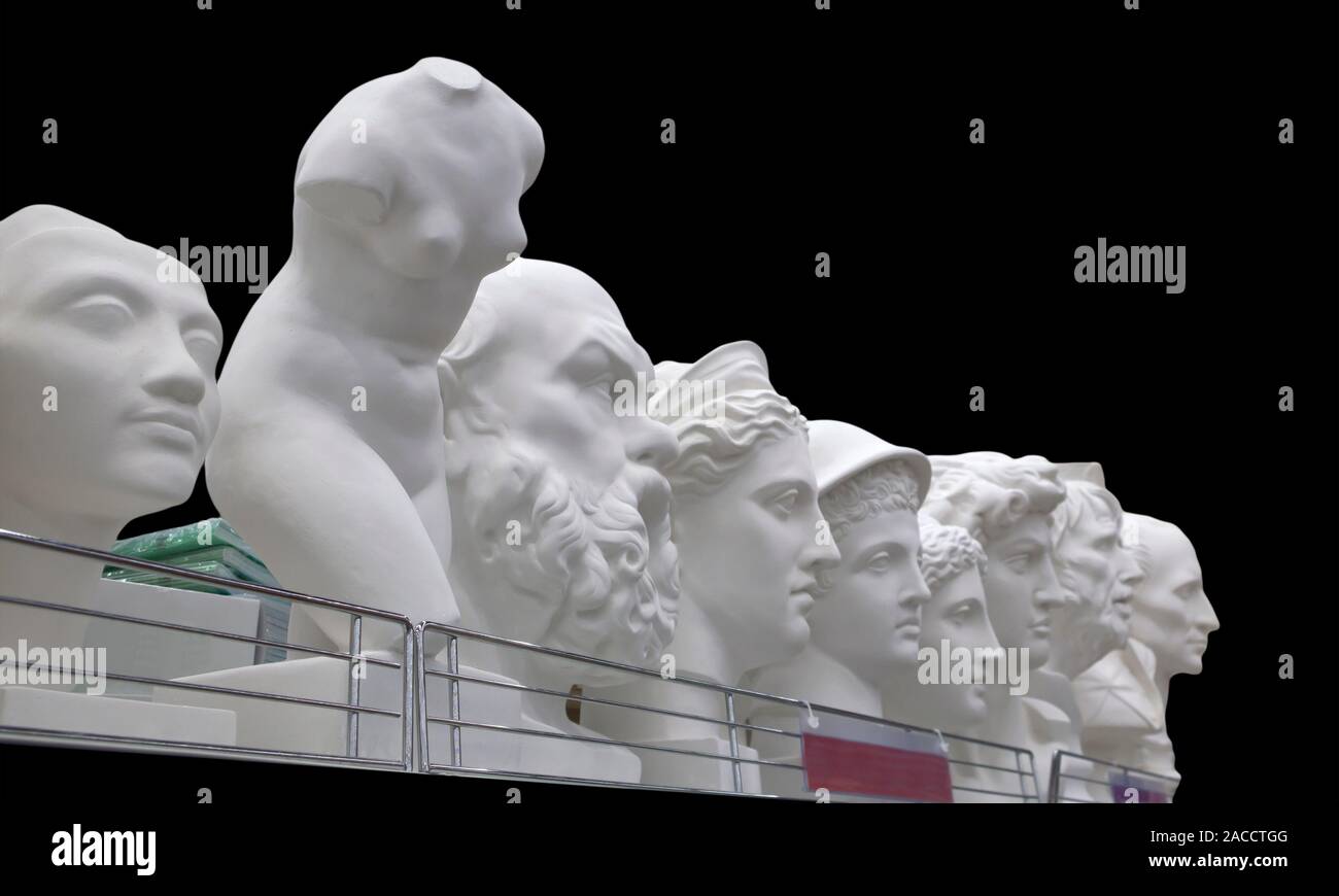 Plaster busts of some historical persons and ancient greek mythological characters isolated on black Stock Photo