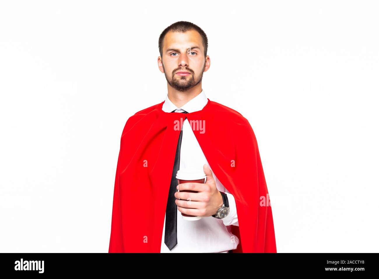 Businessman dressed like superhero drinking coffee Stock Photo
