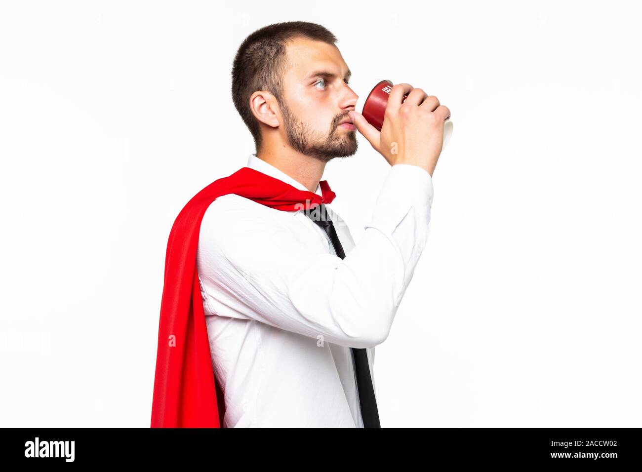 Businessman dressed like superhero drinking coffee Stock Photo