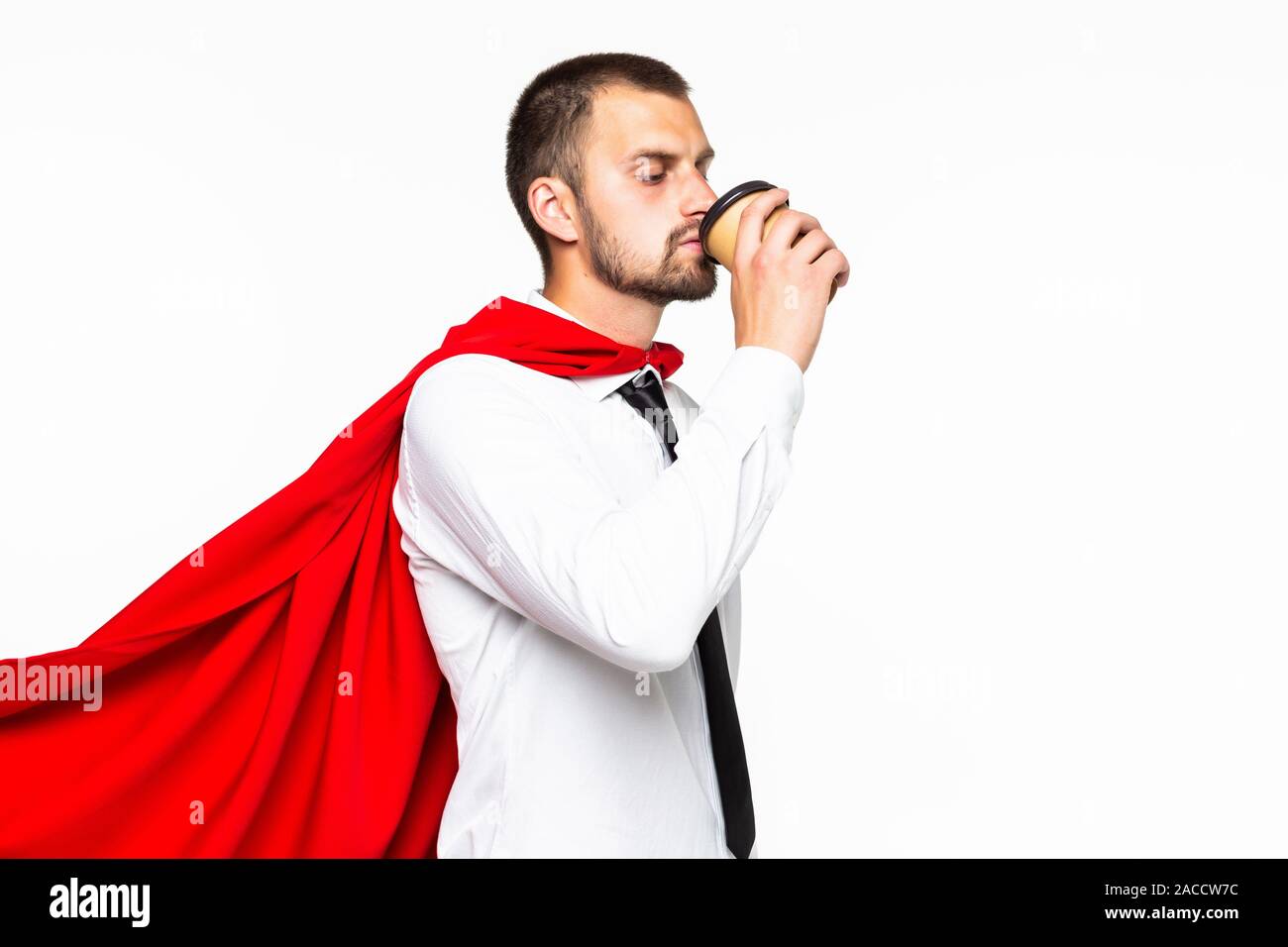 Businessman dressed like superhero drinking coffee Stock Photo