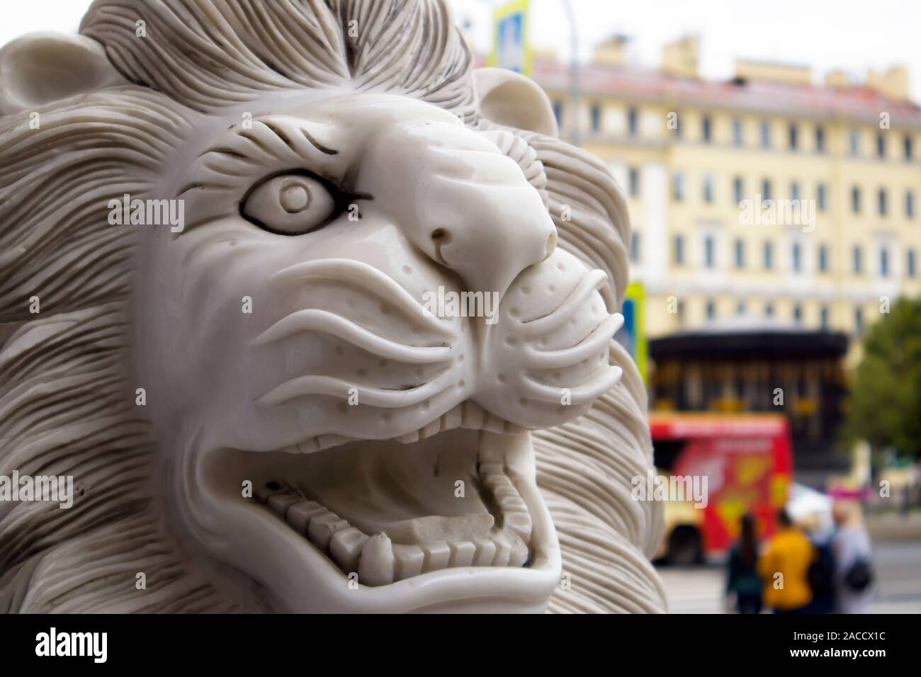 Funny marble smiling lion statue in front of the Chinese restaurant Stock Photo