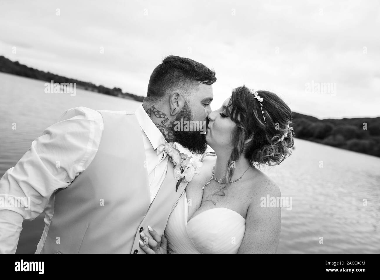 A bride and groom kissing on their big day, celebrating love and happiness and their future together Stock Photo