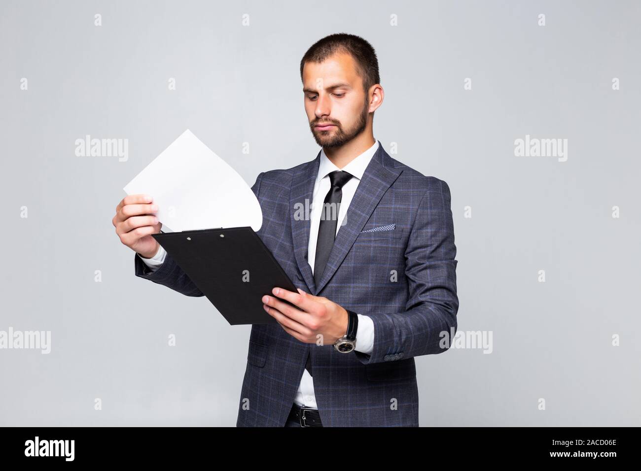 Young business man holding clipboard on white background Stock Photo ...