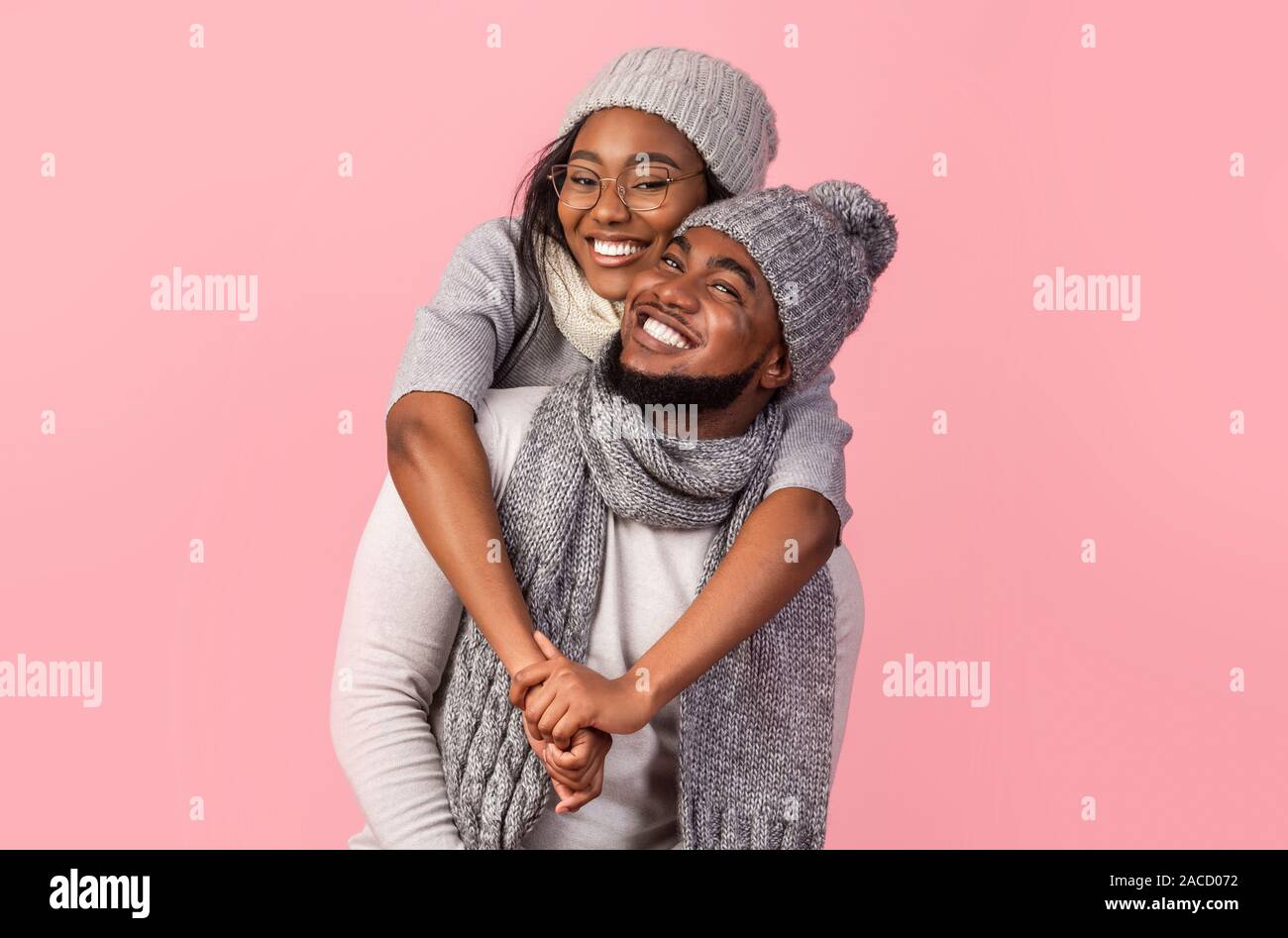Playful black girl hugging her boyfriend from behind Stock Photo - Alamy