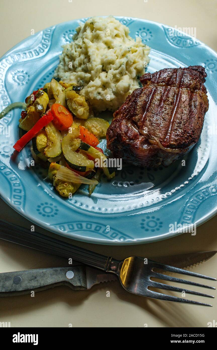 Filet mignon steak dinner with mashed potatoes and grilled vegetables Stock Photo