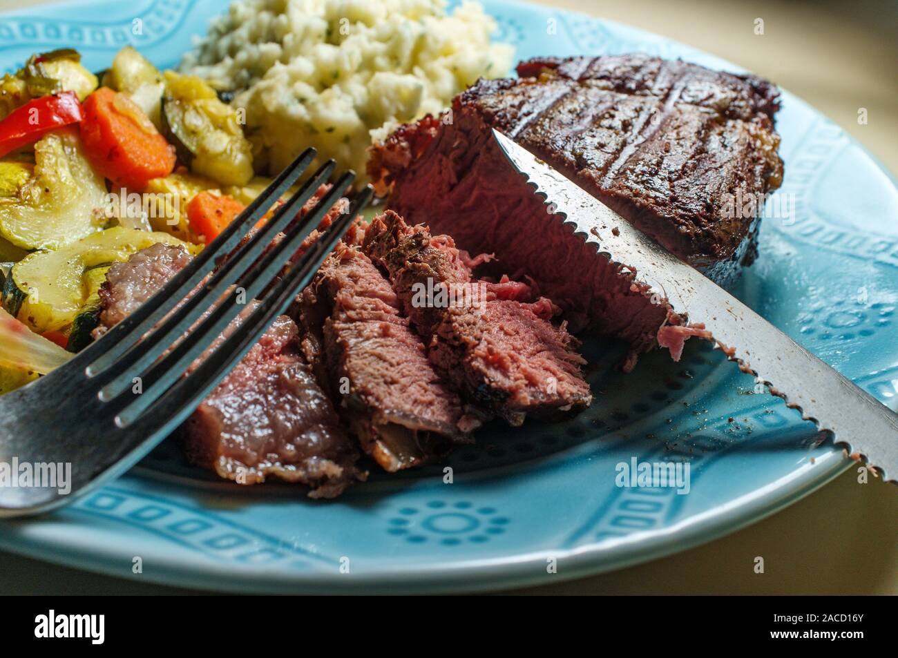 Filet mignon steak dinner with mashed potatoes and grilled vegetables Stock Photo