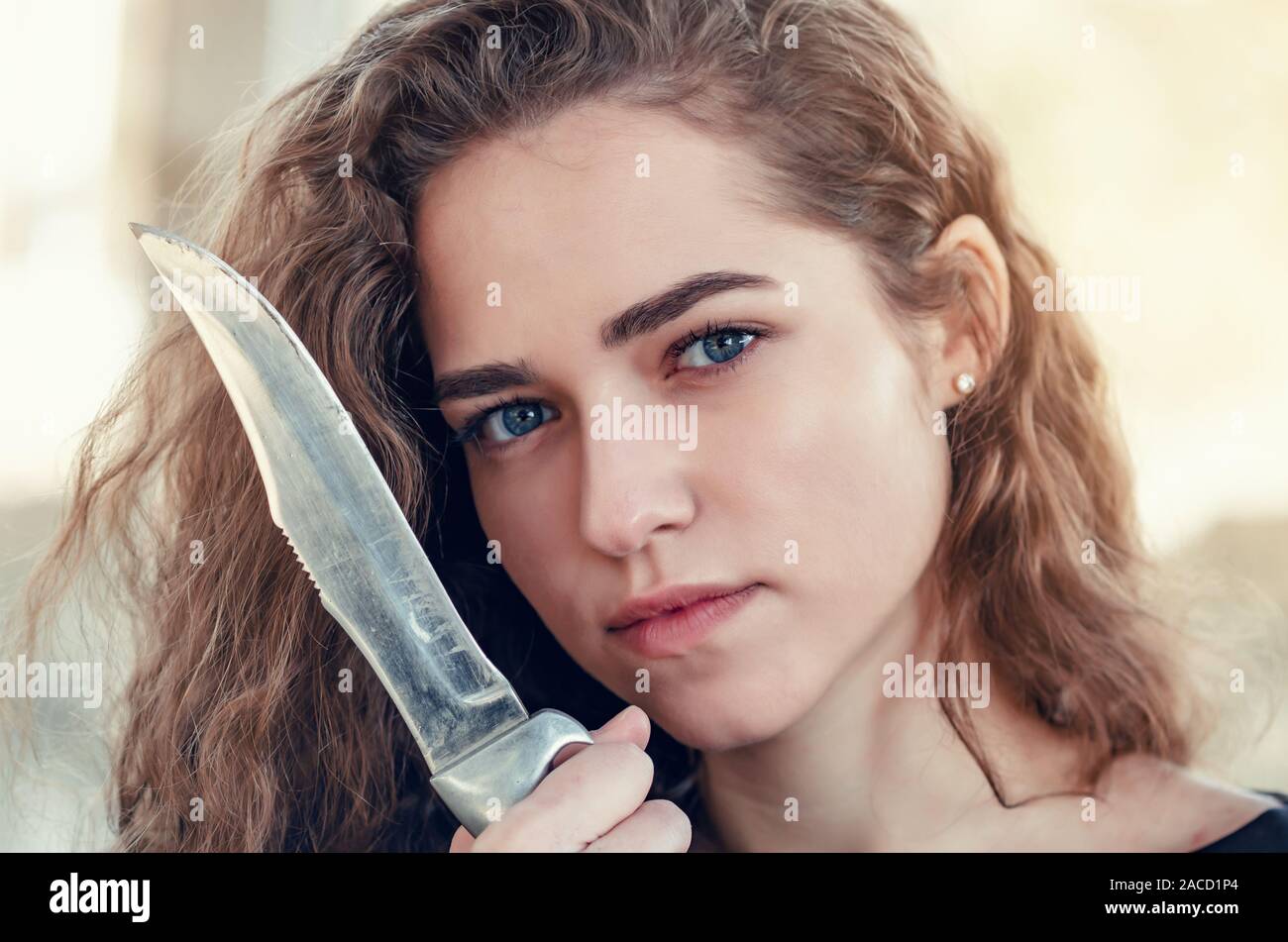 Curly Hair Beautiful Girl With Wavy Hair With Big Knife A Blade