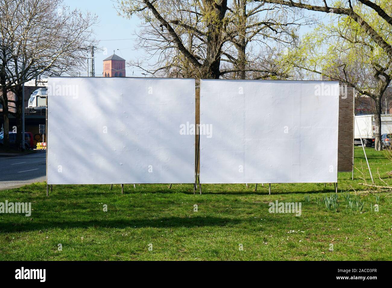 two realistic empty billboards side by side on urban roadside greenery Stock Photo