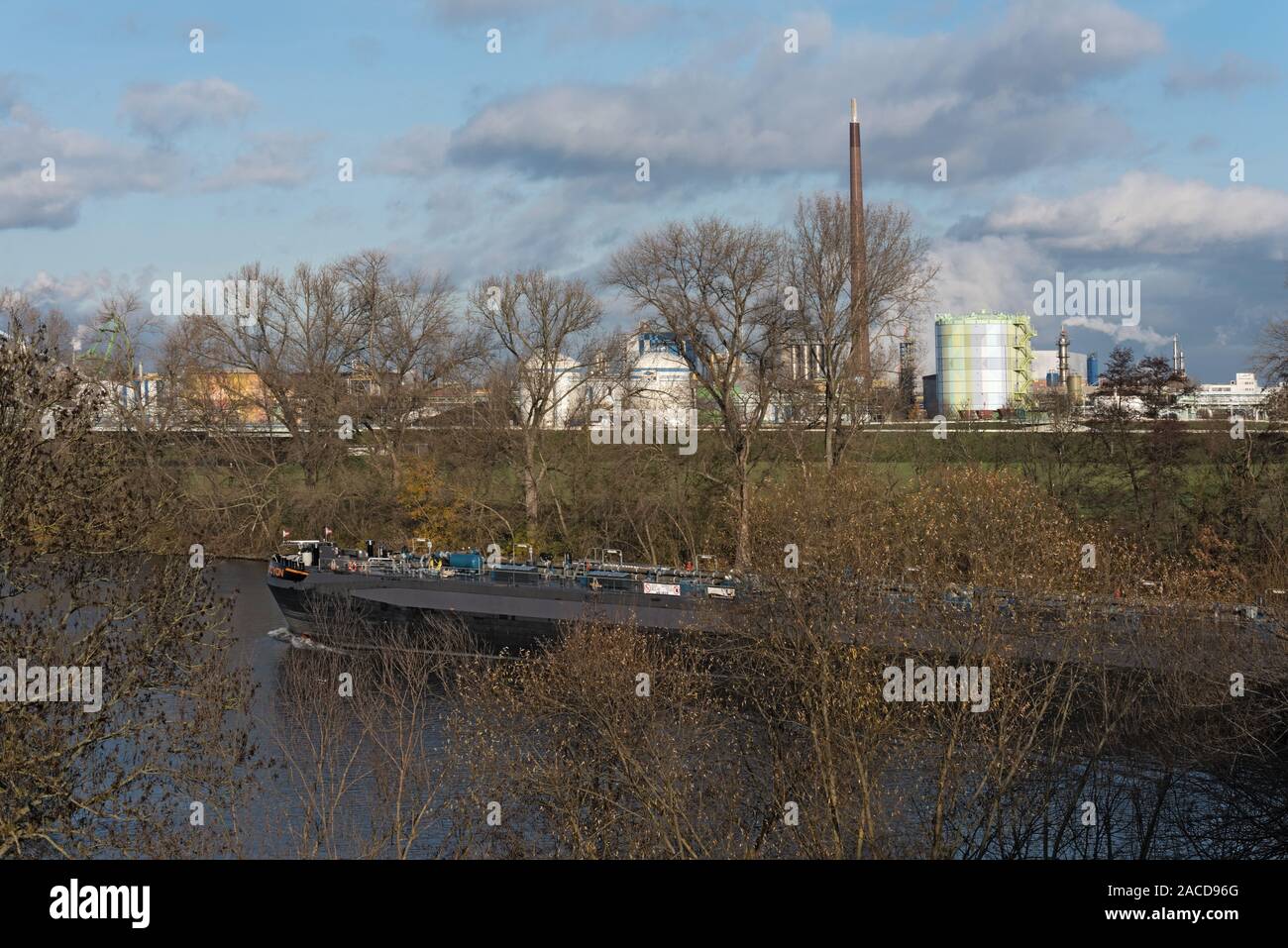 barge in front of industrial plants on the main river in frankfurt hoechst Stock Photo