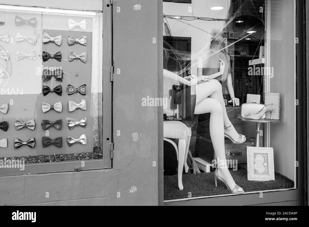 Folded female legs on a mannequin in a shop window, street photography, black and white image, San Cristobal de La Laguna, Tenerife, Canary Islands, S Stock Photo