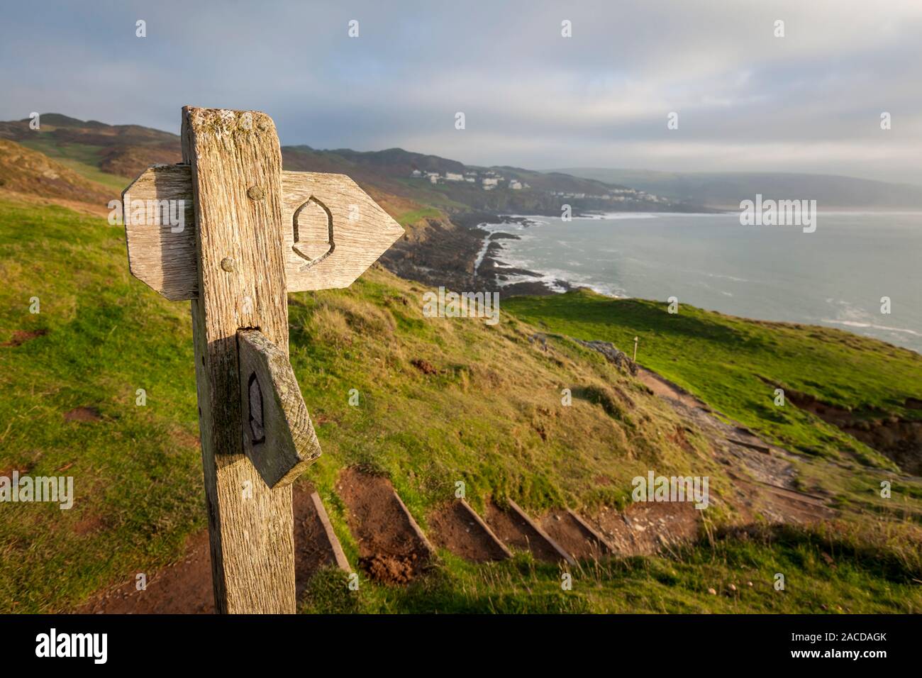 Wooden coastal path sign on the cliffs near Morte Point in North Devon ...
