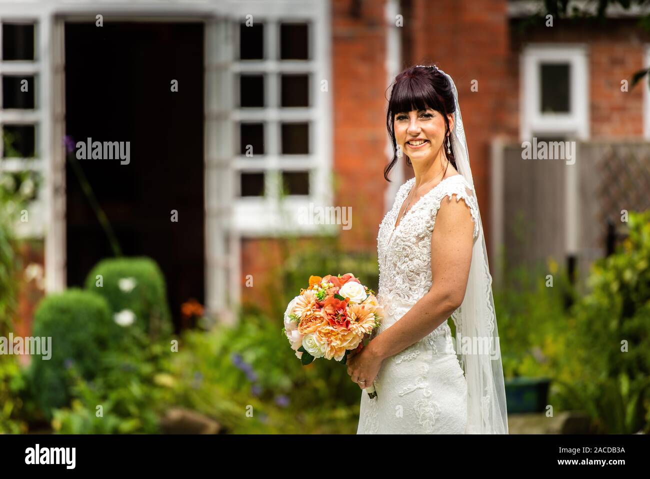 A gorgeous smiling, laughing happy bride after taking her vowels to her husband for a life happy ever after, Wedding photos, wedding photography Stock Photo