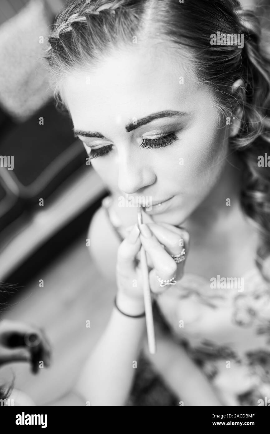 A gorgeous bride getting ready for her special day, bridal preparation having hair and makeup done in preparation for the wedding ceremony Stock Photo