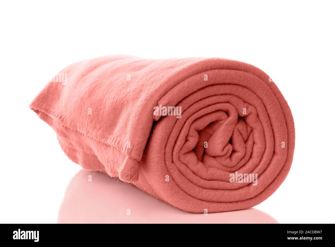 rolled up fleece blanket in coral trend color of the year 2019 Stock Photo