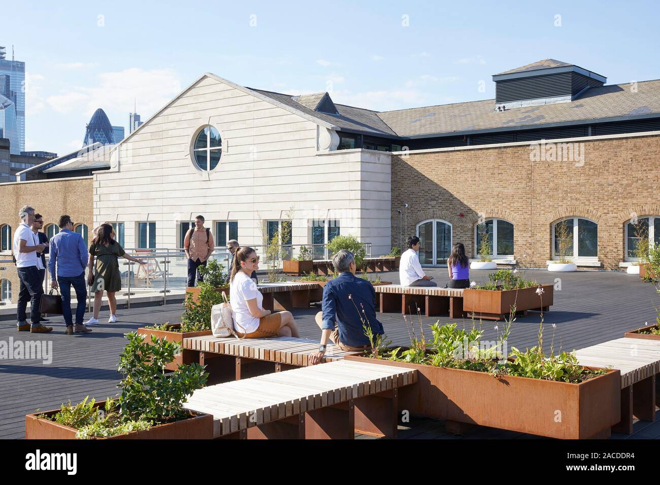 Upper floor waterfront terrace with outdoor seating and planters. Devon