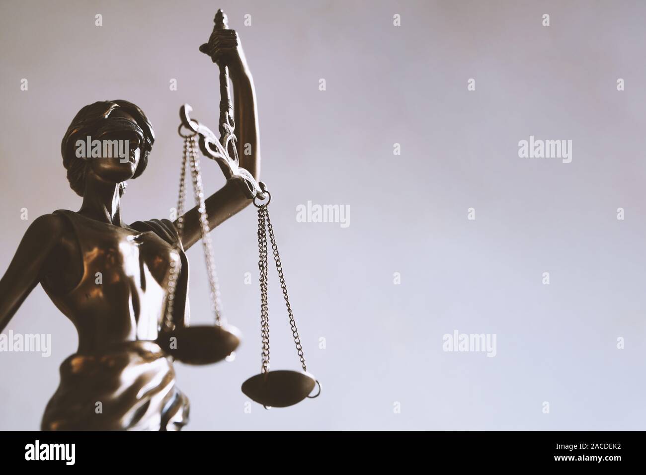 lady justice or justitia - blindfolded figurine holding balance scales - law jurisprudence and impartiality symbol - background with copy space Stock Photo