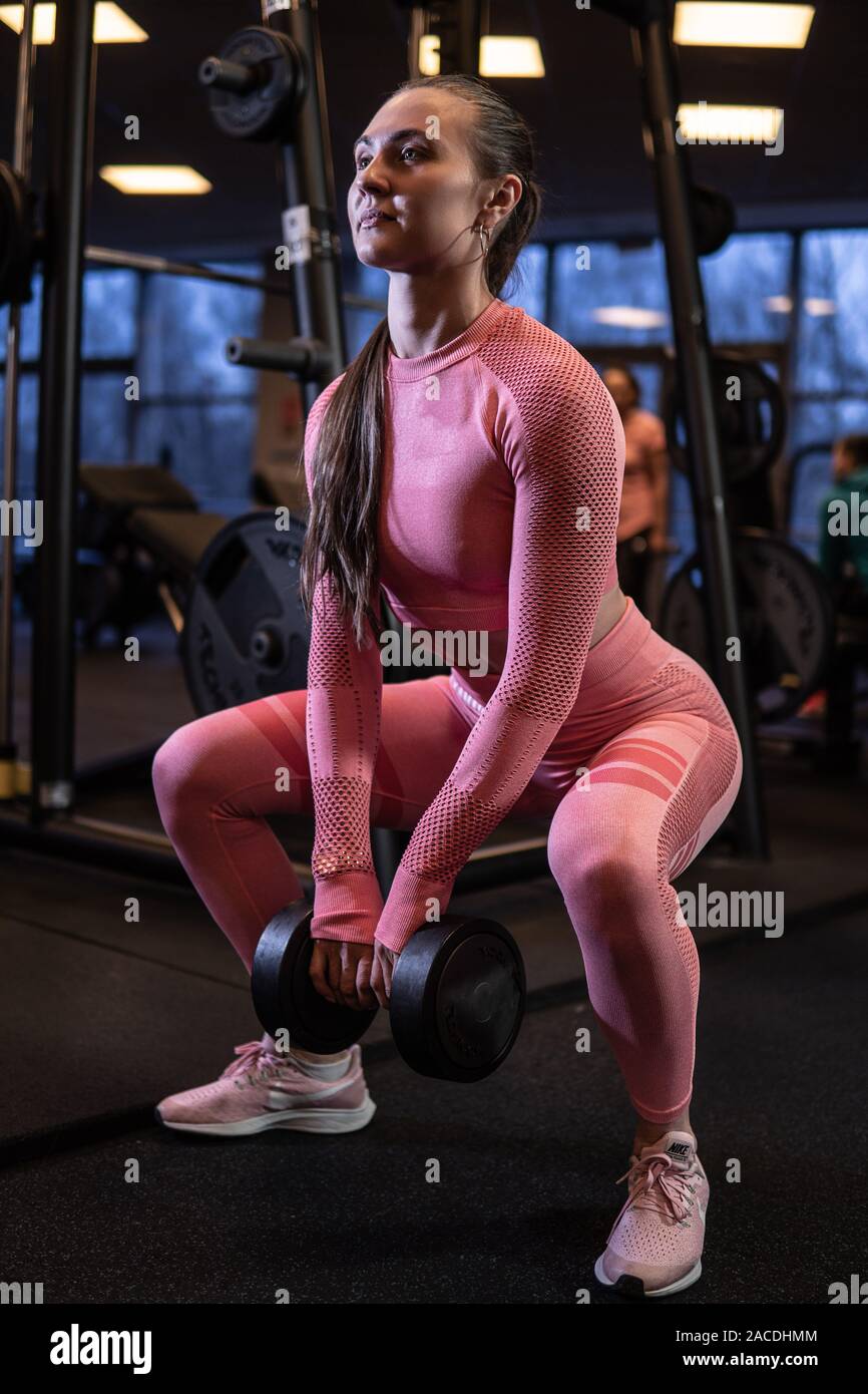 A woman with a barbell in fitness does sports, does exercises. Bench press  shakes her ass Stock Photo - Alamy