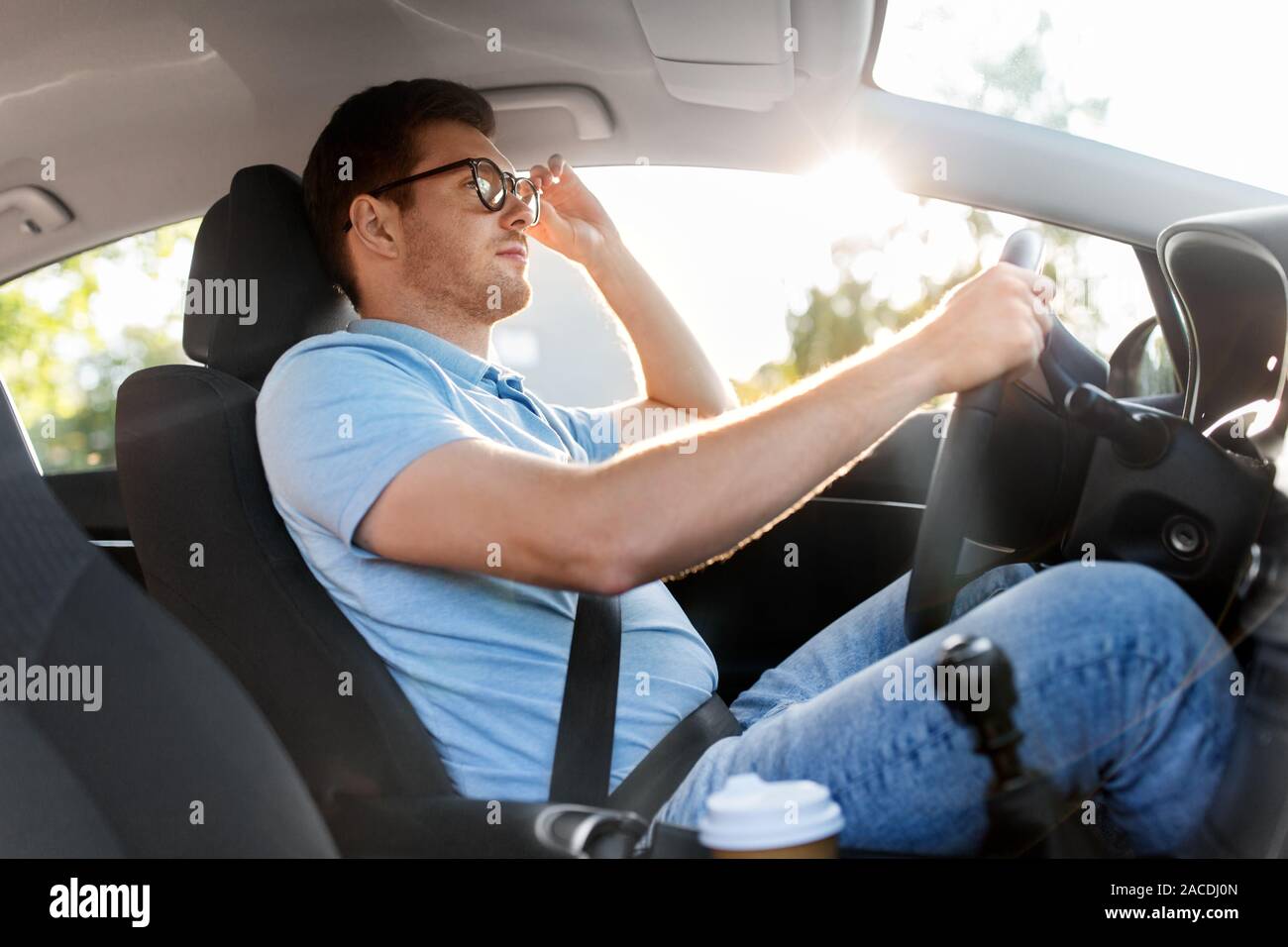 man or driver in glasses driving car in summer Stock Photo