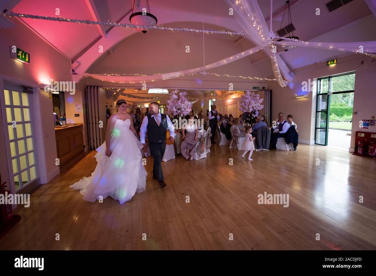 A gorgeous newly wed couple take to the dance floor short after taking their vowels and dedicating their lives to one another, the first dance Stock Photo