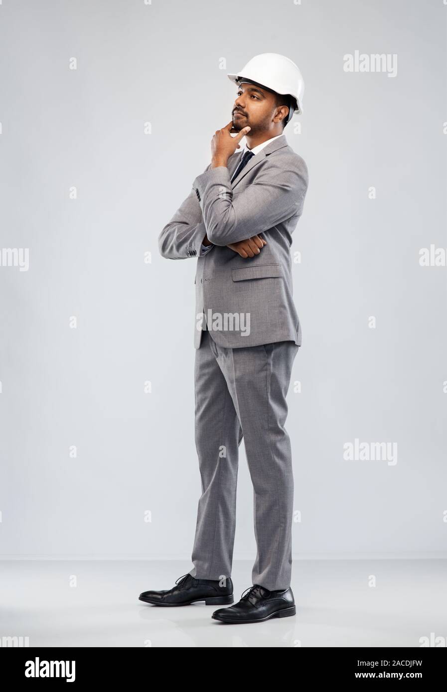indian male architect in helmet over grey Stock Photo