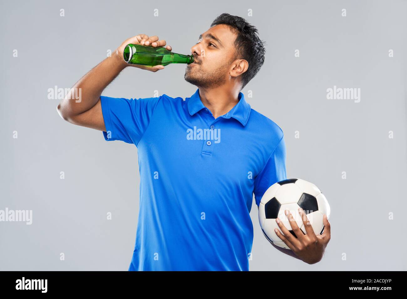 indian male football fan with soccer ball and beer Stock Photo