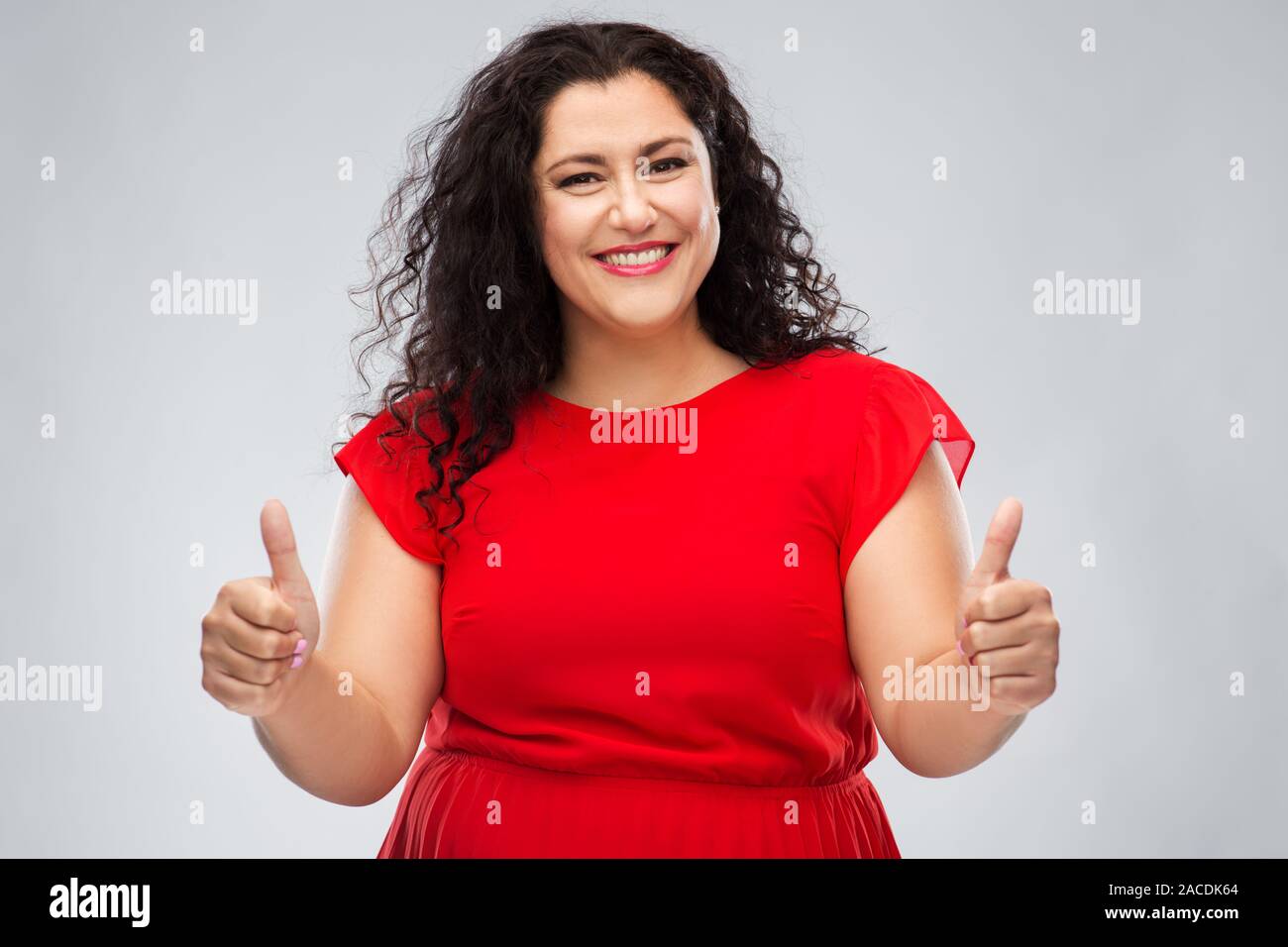 Curly hair woman thumbs up hi-res stock photography and images - Alamy